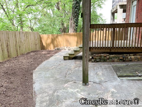 A concrete pathway leads to a wooden deck.