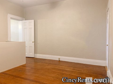 A room with wooden floors and white walls.