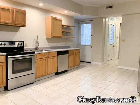 A kitchen with wooden cabinets and a black stove top oven.