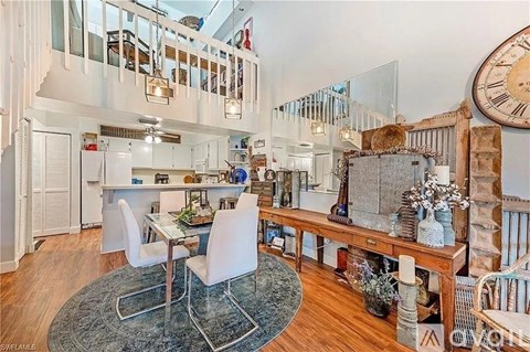 A large open plan living and dining area with a glass table and chairs.