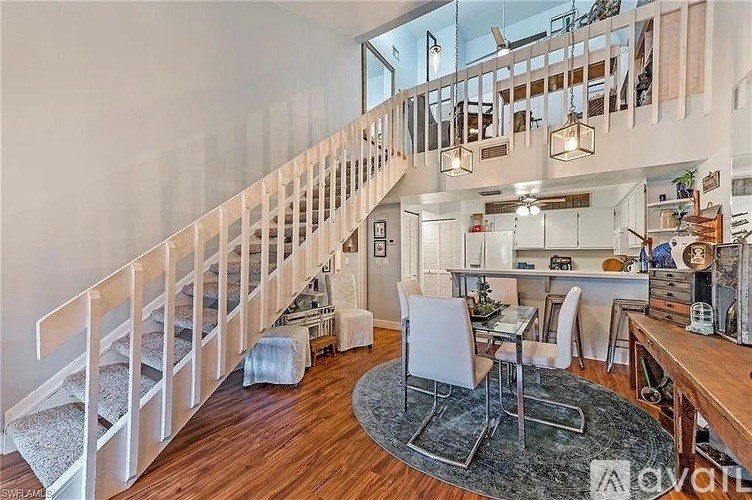 A living room with a staircase leading to the upper floor.