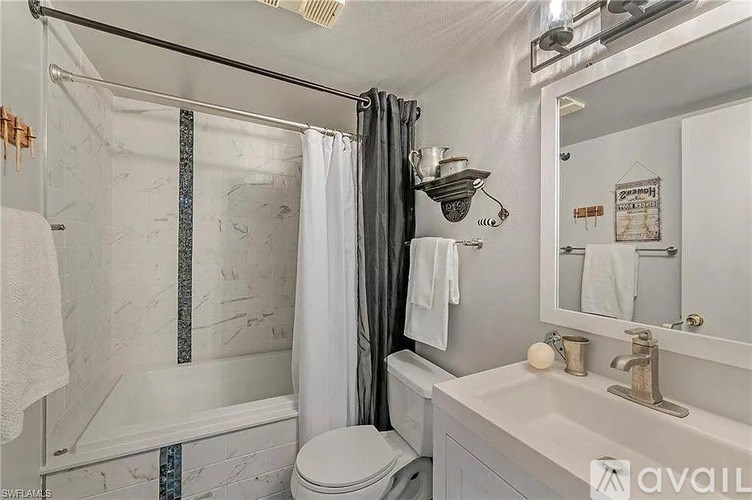 A bathroom with a toilet, sink, and shower.