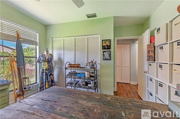 A room with a lot of cabinets and a painting on the wall.