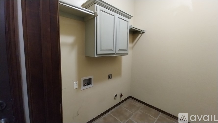 A small room with a cabinet and a door.