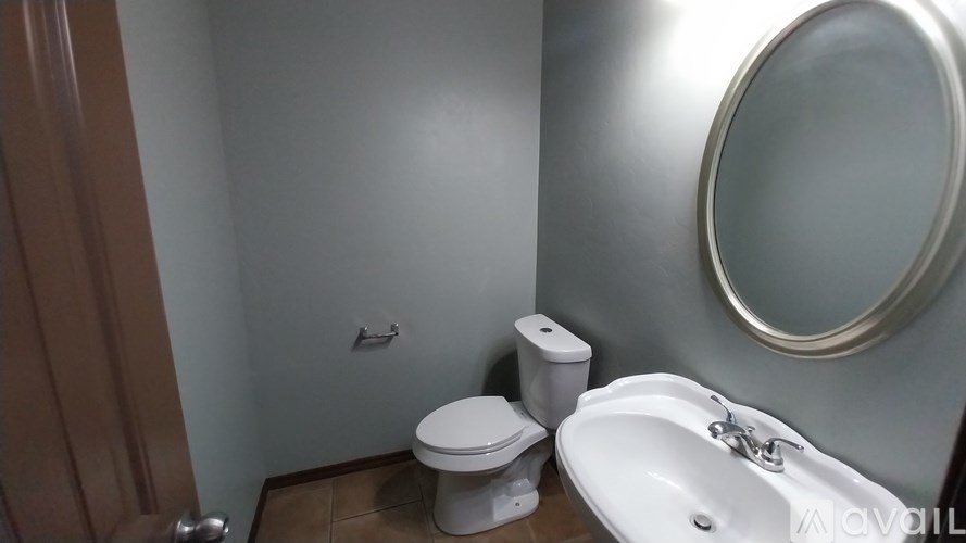 A white toilet sits next to a sink in a bathroom.