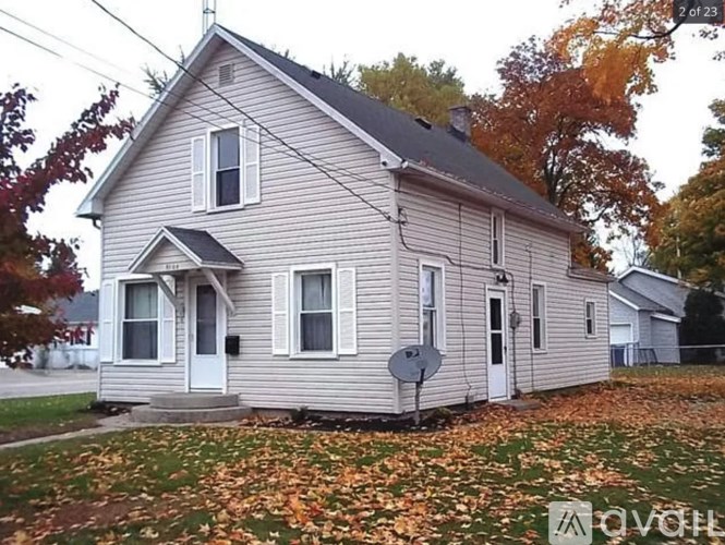 A house with a grey roof and a satellite dish on the front.