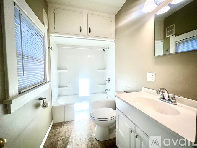 A spacious room with a fan and a window.