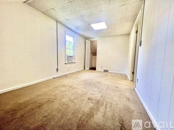 Empty room with a window and a skylight.