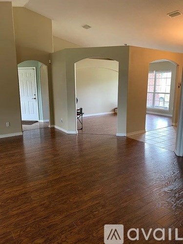 A room with wooden floors and a white door.