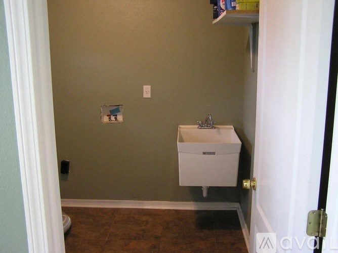 A bathroom with a toilet and a towel rack.