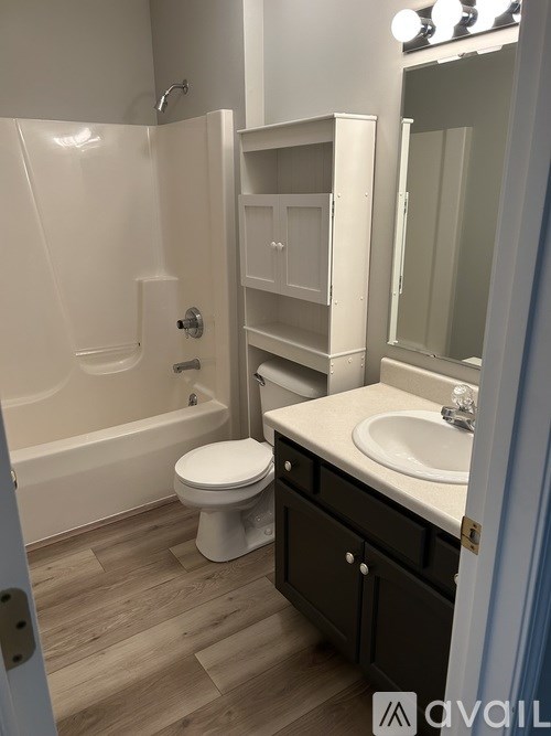 A white toilet sits next to a sink in a bathroom.