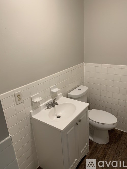 A white sink and toilet in a small bathroom.