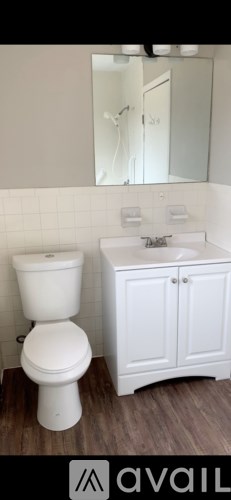 A white toilet and sink in a bathroom.