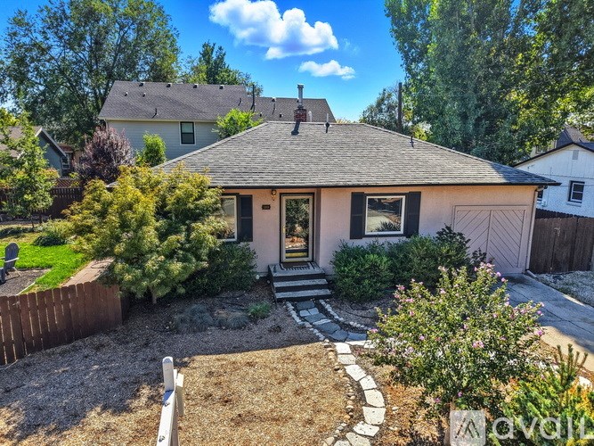 A house with a brown roof and a brown fence.