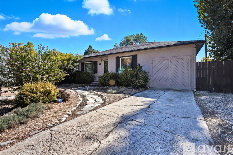 A house with a driveway and a garage door.