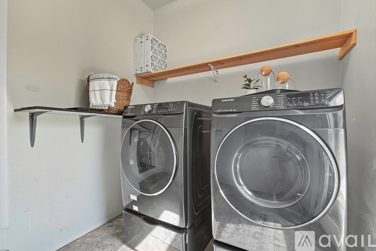 Two front loading washing machines in a laundry room.