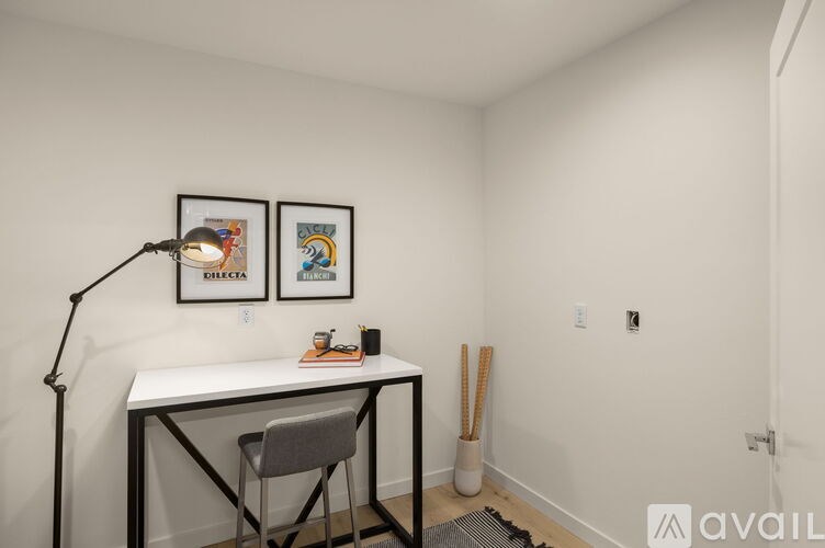 A white desk with a chair and a lamp in a room.