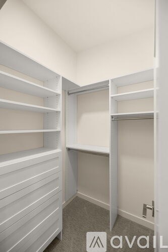 A white closet with shelves and a door.