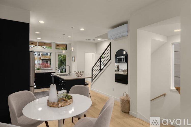 A modern kitchen with a dining table and chairs.