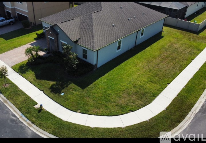 A house with a brown roof and a white fence.