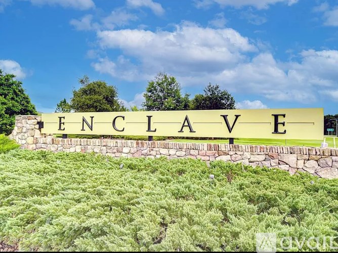 A stone wall with the word "PENCLAVE" written on it.