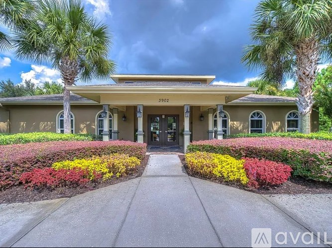 A building with a yellow roof and a sign that reads "AVAIL" in front of it.