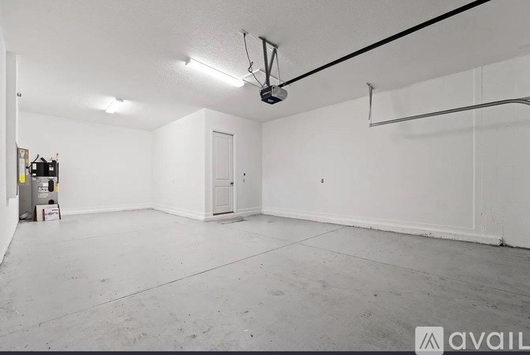 A large empty room with a door and a window.