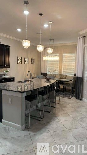 A kitchen with a bar area and a dining table.