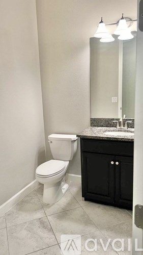 A patio furniture set is displayed on a tiled floor.