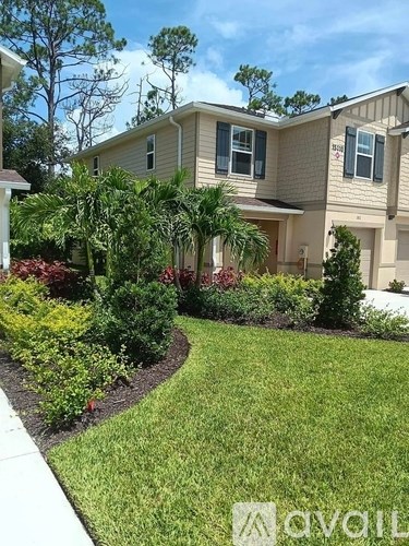 A house with a well-maintained lawn and garden in front.