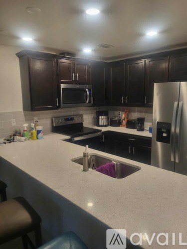 A kitchen with a sink and a refrigerator.