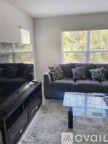 A living room with a couch, a television, and a coffee table.