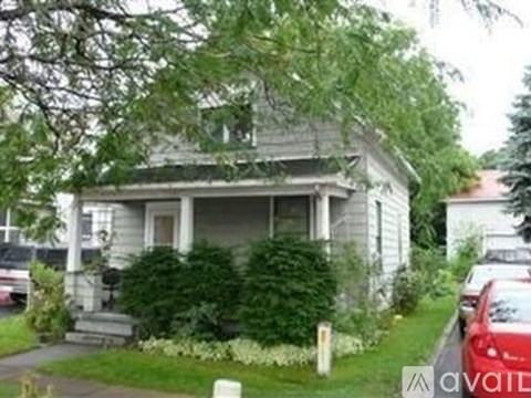 A house with a car parked in front.