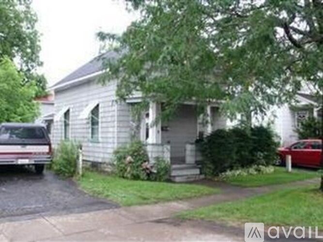 A house with a car parked in front of it.