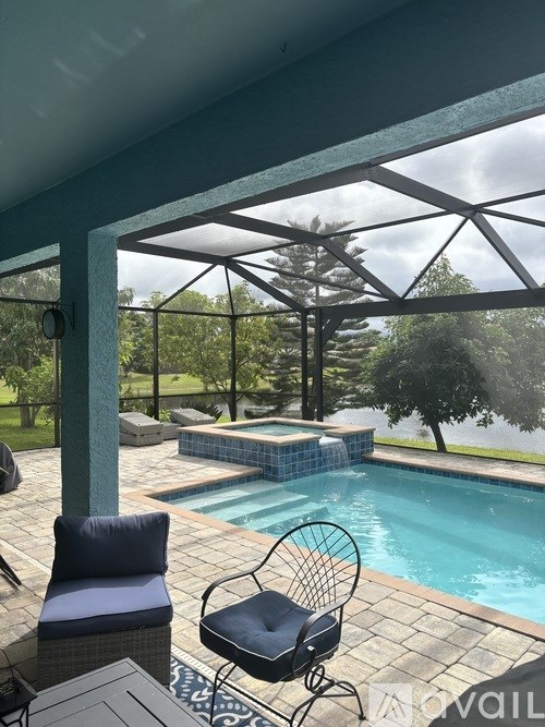 A house with a blue garage door and a brick driveway.