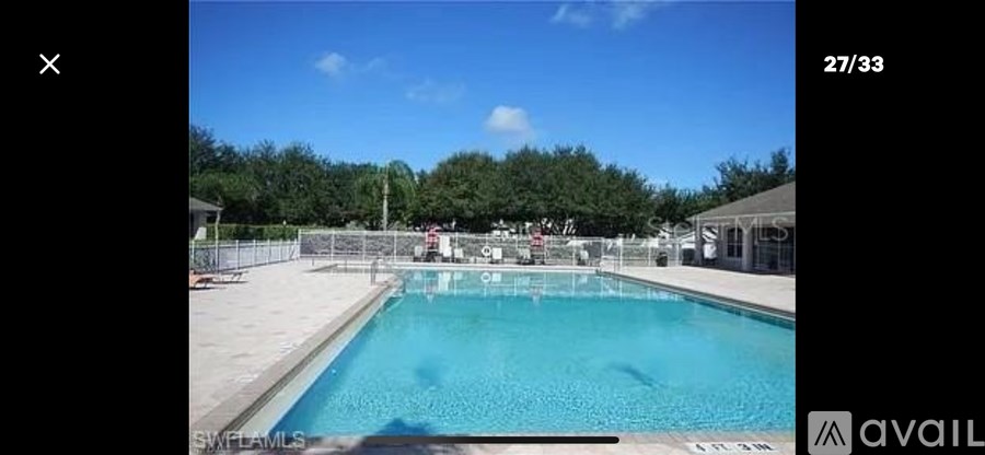 A swimming pool with a clear blue sky in the background.