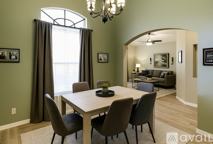 A dining room with a wooden table and chairs.