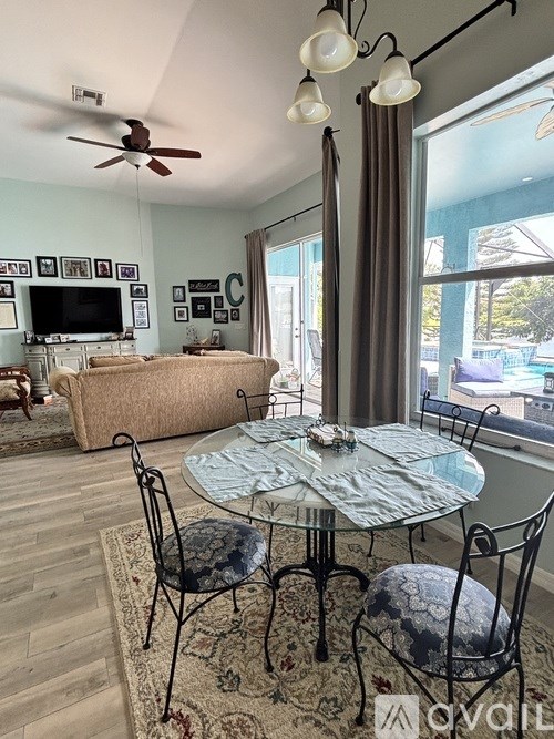 A living room with a glass table and chairs.