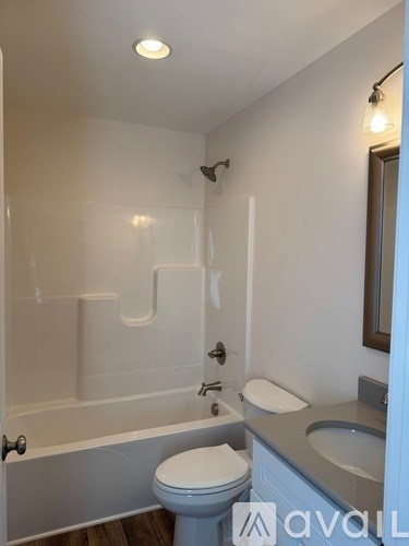 A bathroom with a toilet, sink, and bathtub.