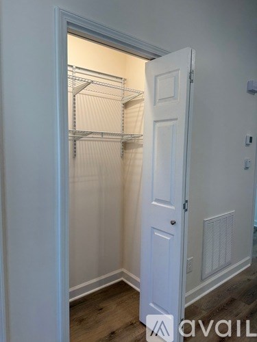 A white door with a shelving unit inside.