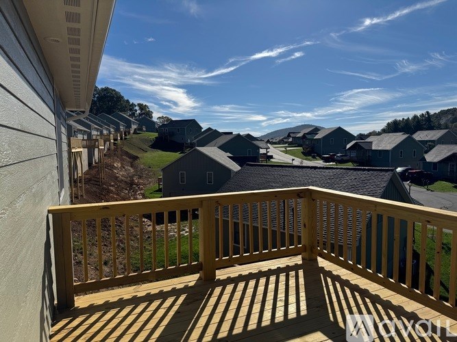 A wooden deck overlooks a residential area.