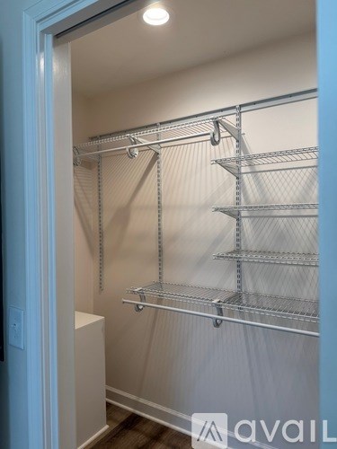 A white closet with shelves and a door.