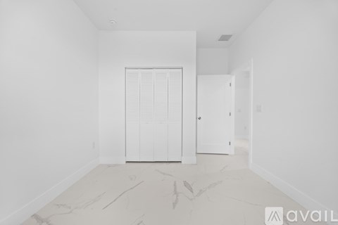 A room with a marble floor and white walls.