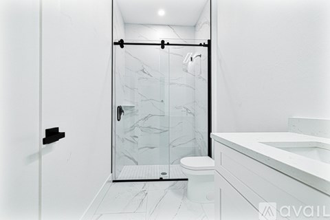 A white bathroom with a walk-in shower.