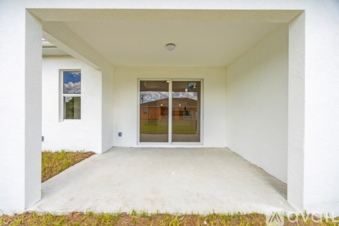A white house with a glass door and a window.