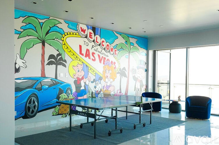 A room with a mural on the wall that says "Welcome to Las Vegas".