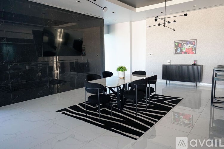 A black and white striped rug sits in front of a black counter.