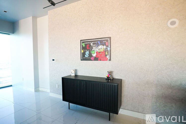 A black radiator is on a white floor in a room.