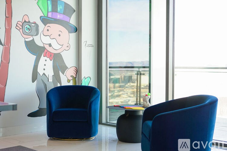 A drawing of a man in a top hat holding a camera is on the wall.