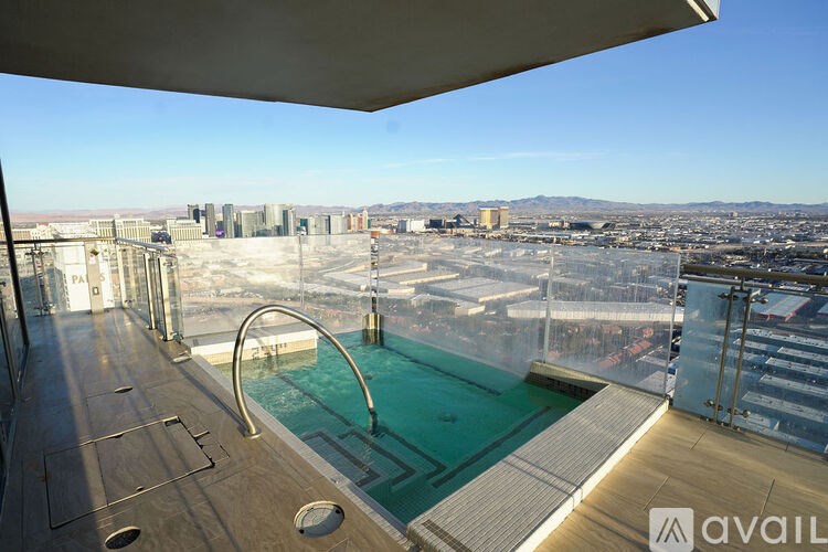 A rooftop pool with a view of the city.